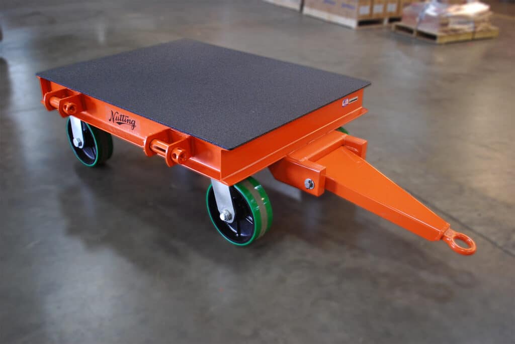 Quad steer heavy duty cart with textured deck and mounting brackets, ideal for precise navigation in manufacturing