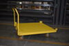 Z33-003-202 steel push cart with corner retaining lips holding a crate of auto components