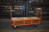 Z35-001-302 caster steer cart with elevated wood deck and two end racks for boxed auto parts
