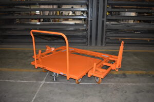 Steel flatbed mother daughter cart delivering pallets to a power infrastructure line